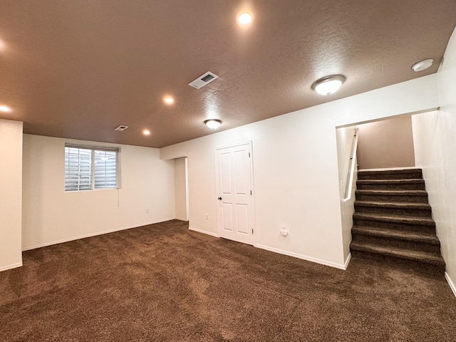 basement with carpet flooring, a textured ceiling, stairs, baseboards, and recessed lighting