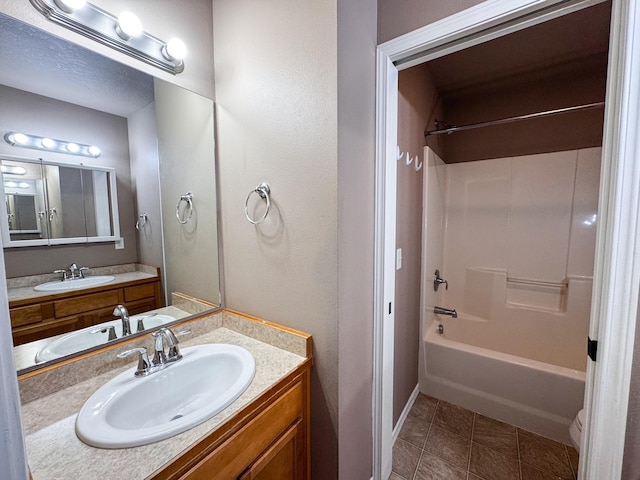 bathroom featuring vanity, shower / bathtub combination, and tile patterned flooring