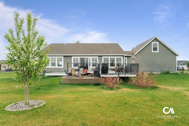 back of house with a deck and a lawn