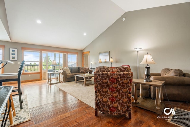 living area with hardwood / wood-style flooring, high vaulted ceiling, and recessed lighting