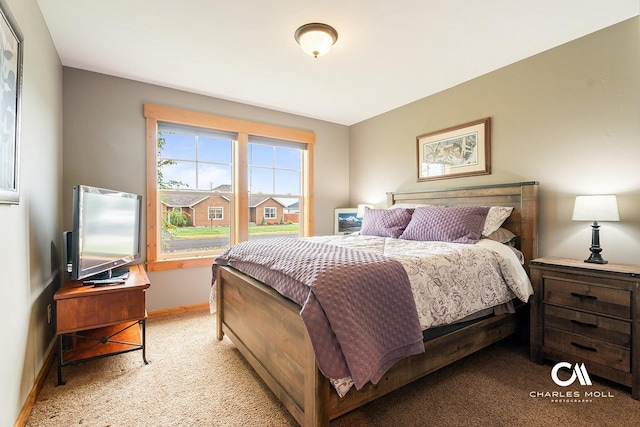 bedroom featuring light colored carpet and baseboards