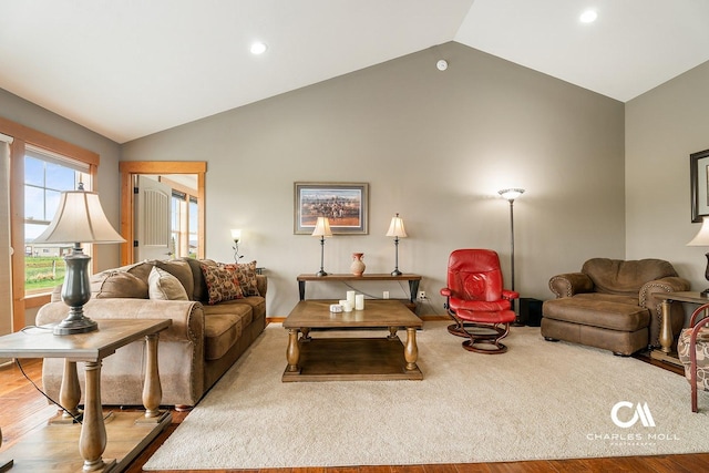living area featuring vaulted ceiling, recessed lighting, wood finished floors, and baseboards