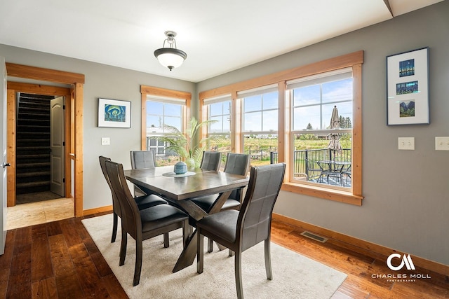 dining space featuring baseboards and wood finished floors
