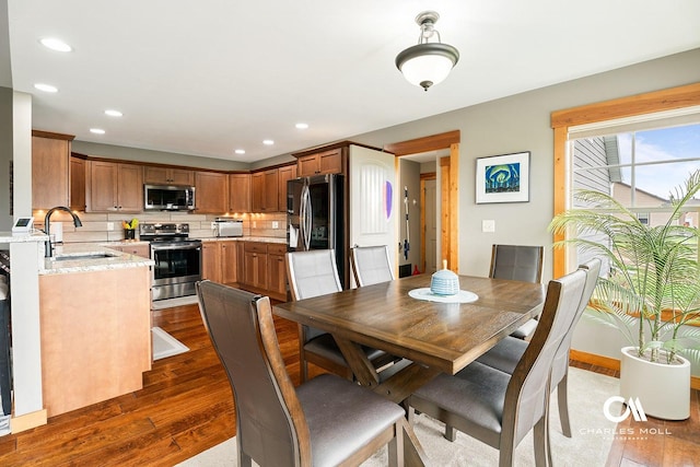 dining area featuring dark wood finished floors and recessed lighting