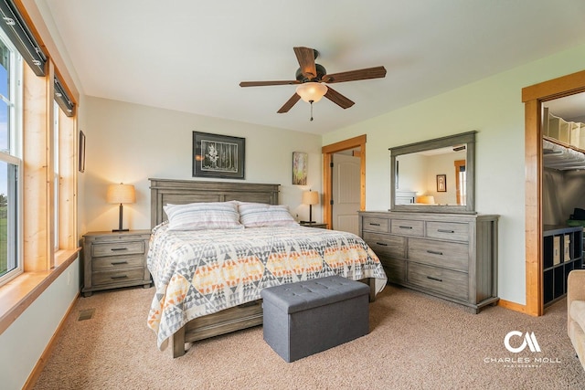 bedroom with light carpet, baseboards, and a ceiling fan