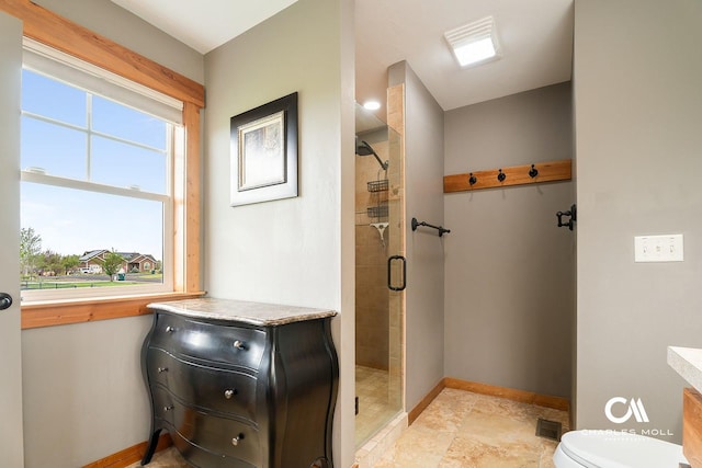 bathroom with baseboards, a shower stall, and toilet