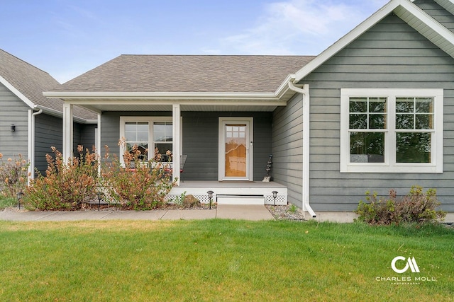 view of front of house featuring a front yard, a porch, and roof with shingles