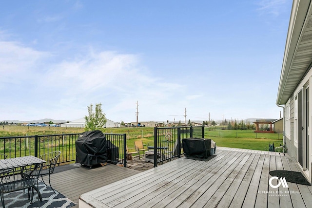 wooden deck with a lawn and grilling area