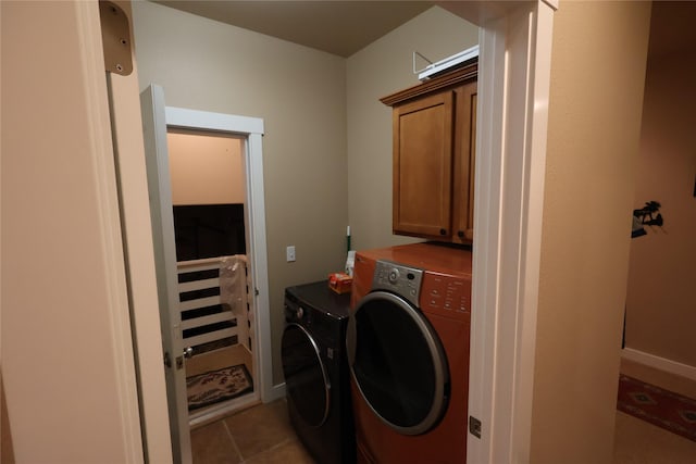 260 Eagle Bend Dr, Bigfork, MT 59911 - laundry area with washer and clothes dryer, cabinet space, and light tile patterned flooring