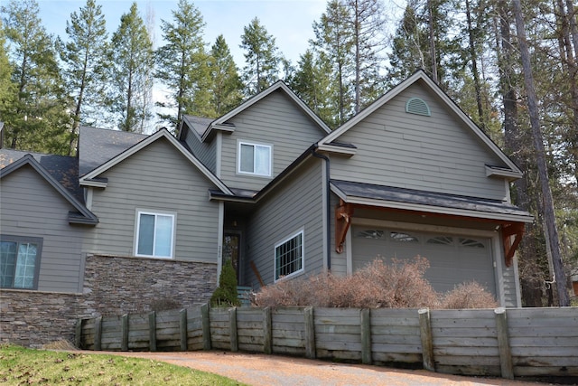 260 Eagle Bend Dr, Bigfork, MT 59911 - traditional-style house featuring an attached garage and stone siding