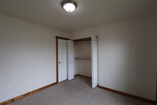 1515 11th St W, Columbia Falls, MT 59912 - unfurnished bedroom with carpet floors, baseboards, and a closet