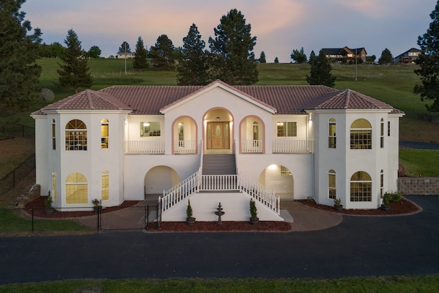 2965 Terrace Dr, Missoula, MT 59803 - mediterranean / spanish-style house featuring stucco siding, stairs, covered porch, and asphalt driveway