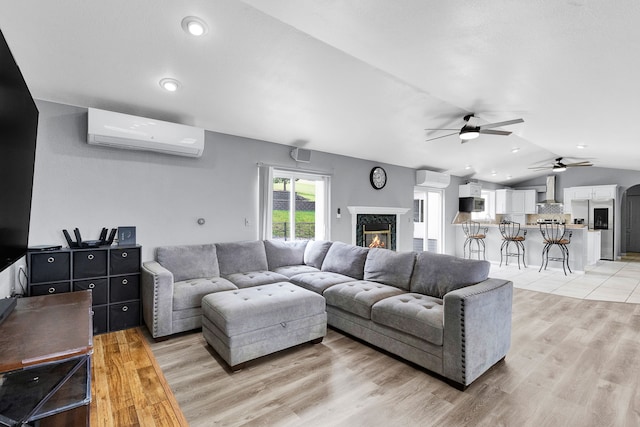 2965 Terrace Dr, Missoula, MT 59803 - living room with a wall mounted AC, a ceiling fan, a high end fireplace, light wood-style floors, and lofted ceiling