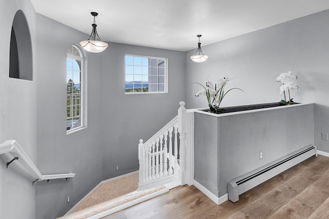 2965 Terrace Dr, Missoula, MT 59803 - staircase featuring baseboard heating, wood finished floors, and baseboards