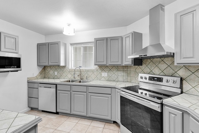 2965 Terrace Dr, Missoula, MT 59803 - kitchen with wall chimney exhaust hood, appliances with stainless steel finishes, and gray cabinets