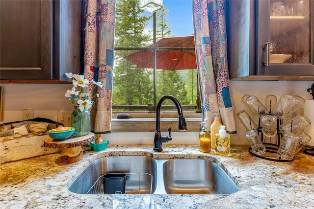 25 Hodge Rdg, Kila, MT 59920 - kitchen view of a sink, dark brown cabinets, and light stone counters