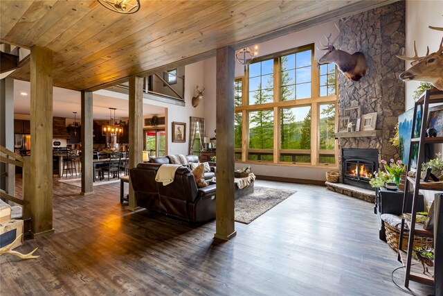 25 Hodge Rdg, Kila, MT 59920 - living room featuring a chandelier, a fireplace, wood finished floors, a high ceiling, and wooden ceiling