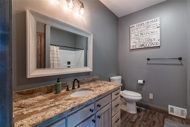 25 Hodge Rdg, Kila, MT 59920 - full bath with wood finished floors, baseboards, vanity, toilet, and a shower with curtain