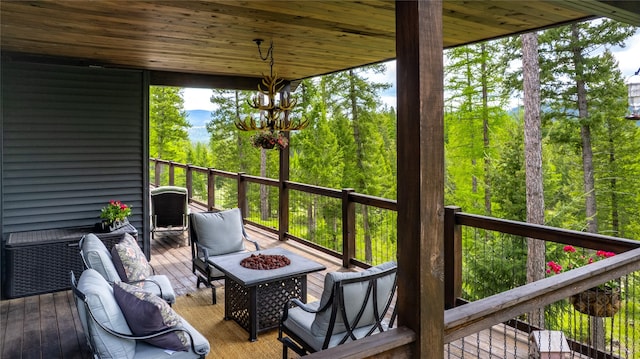 25 Hodge Rdg, Kila, MT 59920 - wooden deck featuring an outdoor fire pit and a wooded view