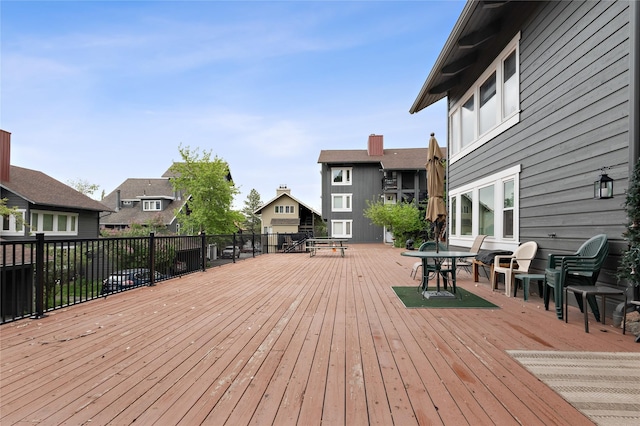 wooden deck with outdoor dining space and a residential view