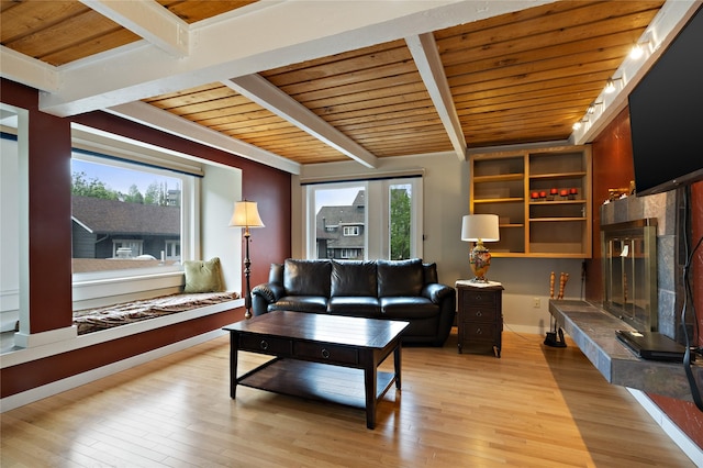 living room with wood ceiling, beamed ceiling, a high end fireplace, and light wood-style flooring