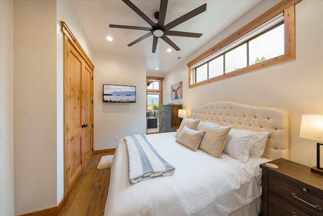 bedroom with wood finished floors, recessed lighting, baseboards, access to outside, and a ceiling fan