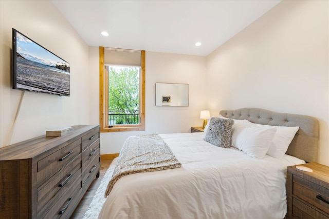 bedroom featuring wood finished floors, baseboards, and recessed lighting