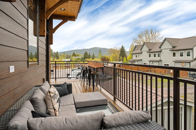balcony featuring a mountain view and an outdoor hangout area