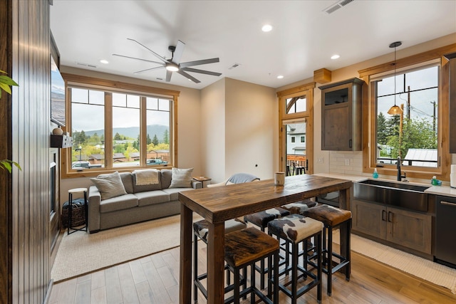 dining room with a ceiling fan, light wood-style flooring, healthy amount of natural light, and recessed lighting