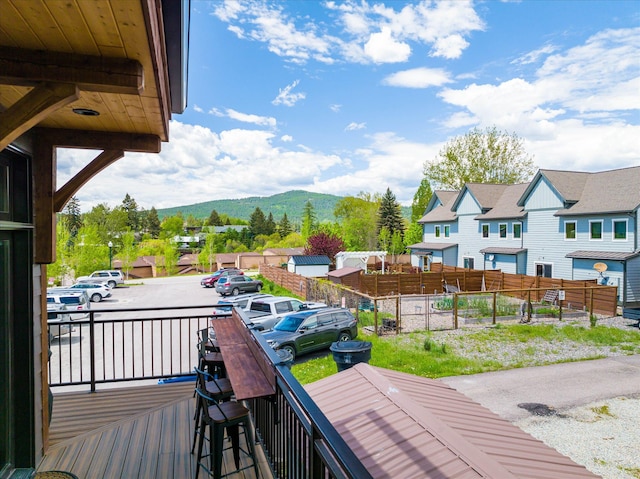 deck with a mountain view and a residential view