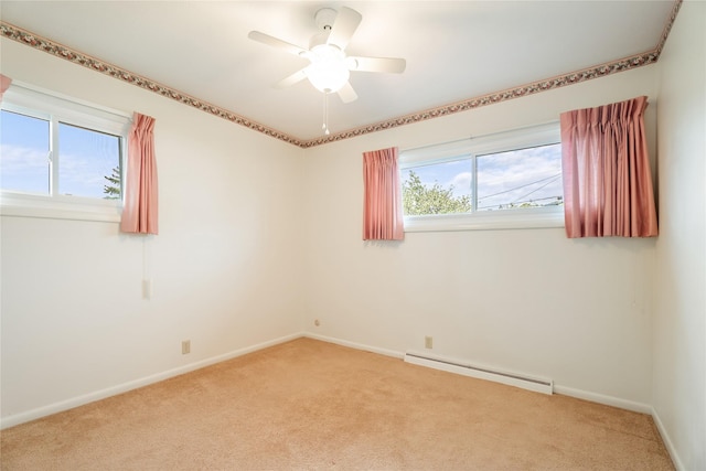 unfurnished room with baseboard heating, light colored carpet, and plenty of natural light