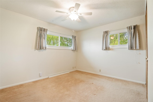 unfurnished room featuring carpet flooring, baseboards, ceiling fan, and a textured ceiling