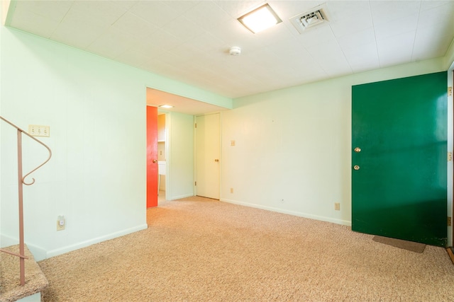 unfurnished room featuring carpet, a smoke detector, and baseboards