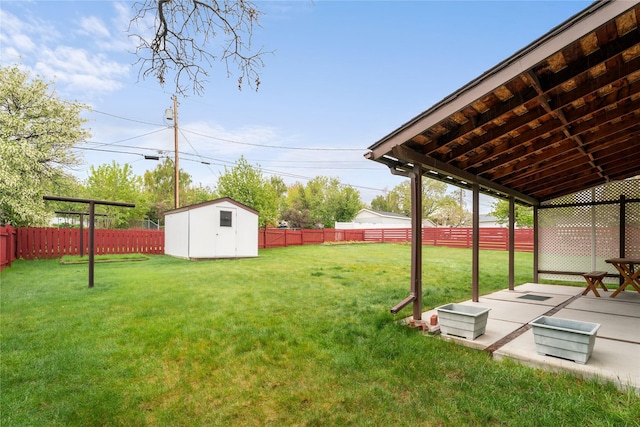 view of yard featuring a patio area, a shed, and an outdoor structure