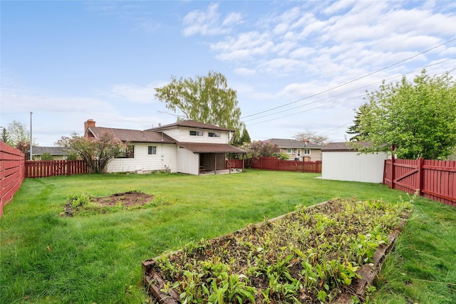 view of yard with a vegetable garden and an outdoor structure