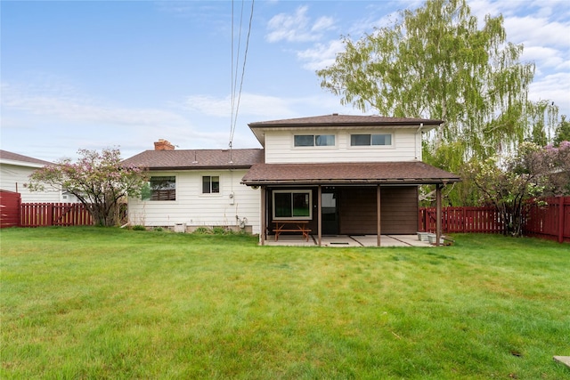 back of property with a patio and a shingled roof