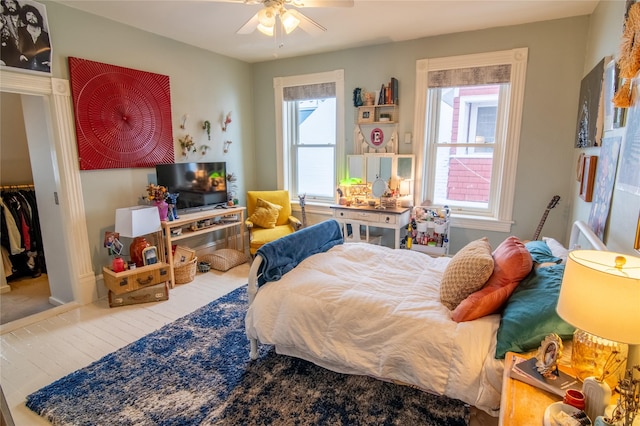 bedroom with a ceiling fan and wood finished floors
