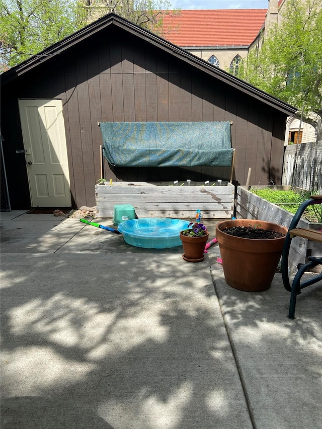 view of outbuilding featuring fence