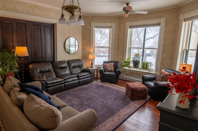 living area with hardwood / wood-style flooring, plenty of natural light, ceiling fan, and a chandelier