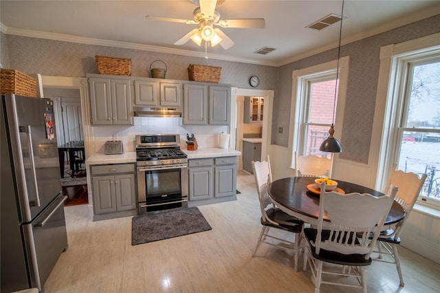 kitchen with stainless steel appliances, gray cabinets, under cabinet range hood, light wood finished floors, and light countertops