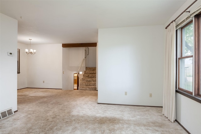 unfurnished room with a chandelier, carpet, stairway, and baseboards