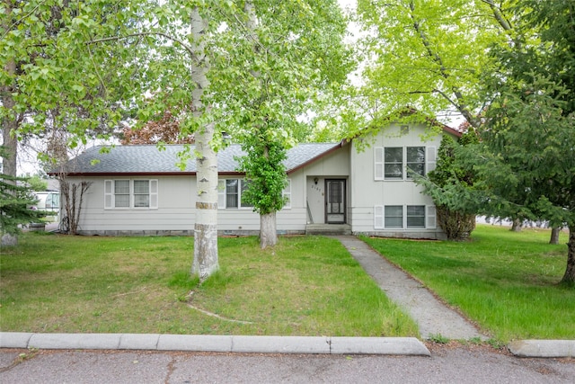 split level home with a front yard and roof with shingles