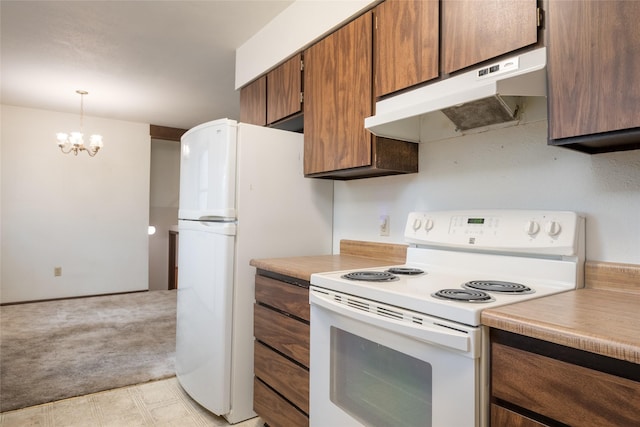 kitchen featuring white appliances, under cabinet range hood, light countertops, a chandelier, and brown cabinets