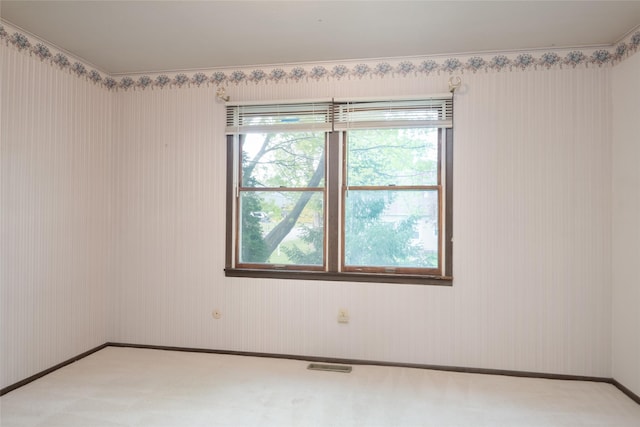 empty room with light colored carpet and baseboards