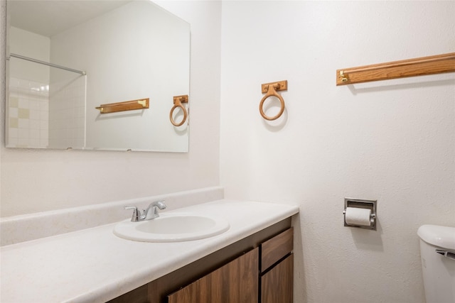 full bathroom with toilet and vanity