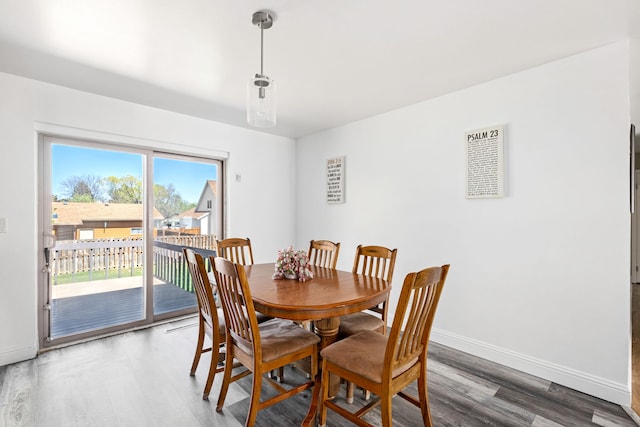 dining area with wood finished floors and baseboards