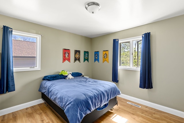 bedroom featuring wood finished floors and baseboards