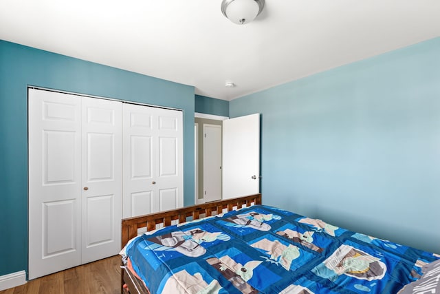 bedroom featuring wood finished floors and a closet