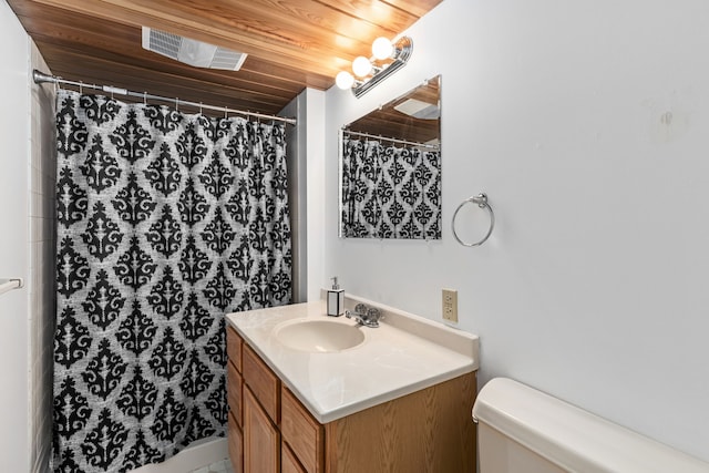bathroom with toilet, vanity, and a shower with curtain