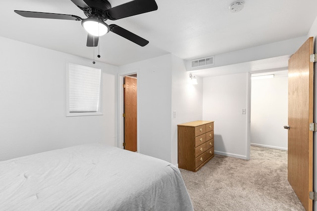 bedroom with light carpet, ceiling fan, and baseboards